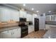 Modern kitchen featuring granite countertops, white cabinetry, stainless steel appliances, and a gas range for culinary enthusiasts at 188 Macedonia Rd, White, GA 30184
