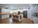 Spacious kitchen featuring white cabinets, granite countertops, stainless steel appliances, and a functional center island with bar stools at 188 Macedonia Rd, White, GA 30184
