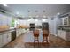 Bright kitchen with white cabinets, granite countertops, stainless steel appliances, and a center island perfect for meal preparation at 188 Macedonia Rd, White, GA 30184