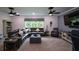 Cozy living room with comfortable seating, a large TV, and neutral decor with ceiling fans at 188 Macedonia Rd, White, GA 30184