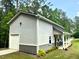Side view of the outbuilding featuring a garage door and a covered porch at 188 Macedonia Rd, White, GA 30184