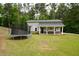 The outbuilding has a covered porch and room for fun with a trampoline at 188 Macedonia Rd, White, GA 30184