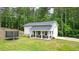 Another view of the outbuilding featuring a covered porch, garage, and trampoline at 188 Macedonia Rd, White, GA 30184