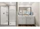 Bathroom showcasing a glass-enclosed shower and double sink vanity with modern fixtures and finishes at 1911 Colestock Se Ave, Conyers, GA 30094
