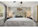 Comfortable main bedroom features accent wall, bedside lamps and windows at 1911 Colestock Se Ave, Conyers, GA 30094