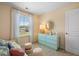 Bright bedroom with a view, pastel decor, and comfortable daybed for relaxation at 1911 Colestock Se Ave, Conyers, GA 30094