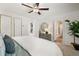 This bedoom has a decorative dresser, ceiling fan, and entry to an en-suite bathroom at 1911 Colestock Se Ave, Conyers, GA 30094