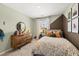 Stylish bedroom featuring geometric wall design, natural light, and wooden dresser at 1911 Colestock Se Ave, Conyers, GA 30094