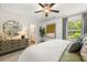 Cozy bedroom featuring decorative mirrors, dresser, and a window overlooking greenery at 1911 Colestock Se Ave, Conyers, GA 30094