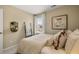 Cozy bedroom with natural light, decorative mirror and blanket ladder, and comfy bed at 1911 Colestock Se Ave, Conyers, GA 30094