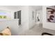 Hallway with carpet and artwork, leading to various rooms within the home at 1911 Colestock Se Ave, Conyers, GA 30094