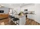 Kitchen island flows into living area with stainless appliances, granite counters, and barstool seating at 1911 Colestock Se Ave, Conyers, GA 30094