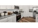 Modern kitchen featuring stainless appliances, granite counters, and white cabinets at 1911 Colestock Se Ave, Conyers, GA 30094