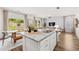 Open-concept kitchen with granite counters and view of dining area and sliding glass doors at 1911 Colestock Se Ave, Conyers, GA 30094