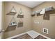 Functional laundry room with shelving, utility connections, and modern flooring at 1911 Colestock Se Ave, Conyers, GA 30094