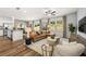 Bright, open-concept living room featuring hardwood floors, stylish furnishings, and a cozy sectional sofa at 1911 Colestock Se Ave, Conyers, GA 30094