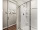 Bright bathroom shower featuring a glass enclosure and built-in shelving for storage at 1911 Colestock Se Ave, Conyers, GA 30094