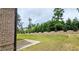 A spacious backyard with a concrete patio area for entertaining and a lush, green lawn at 1961 Ecoland Dr, Grayson, GA 30017