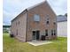Back of house with brick siding, multiple windows, a sliding glass door, and a lawn at 1961 Ecoland Dr, Grayson, GA 30017