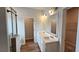 Bathroom with double sink vanity, framed mirror, and door to closet at 1961 Ecoland Dr, Grayson, GA 30017