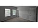 Neutral bedroom with carpet, two windows, and a white door at 1961 Ecoland Dr, Grayson, GA 30017
