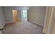 Bedroom featuring neutral walls, carpet flooring, a walk-in closet, and windows with blinds at 1961 Ecoland Dr, Grayson, GA 30017