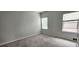 This bedroom has neutral walls, two windows for natural light, and plush carpeting at 1961 Ecoland Dr, Grayson, GA 30017