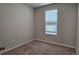 Bright, carpeted bedroom featuring a neutral color scheme, a large window, and ample natural light at 1961 Ecoland Dr, Grayson, GA 30017