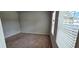 Empty bedroom with light brown carpet, gray walls, and a window with white blinds at 1961 Ecoland Dr, Grayson, GA 30017