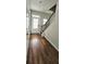 Hallway with beautiful wood-look floors, white walls, stairs and a white door at 1961 Ecoland Dr, Grayson, GA 30017