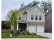 Charming two-story home with a stone and brick facade, a well-manicured lawn, and a two-car garage at 1961 Ecoland Dr, Grayson, GA 30017