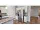 A well-equipped kitchen includes stainless appliances, granite counters, and modern white cabinetry at 1961 Ecoland Dr, Grayson, GA 30017