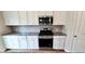 A functional kitchen includes stainless steel appliances, granite countertops, and ample white cabinets at 1961 Ecoland Dr, Grayson, GA 30017