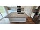 Kitchen island has a granite countertop and a stainless steel sink overlooking stainless steel appliances at 1961 Ecoland Dr, Grayson, GA 30017