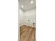 Laundry room featuring wood-look flooring, white walls, and a wire shelving unit at 1961 Ecoland Dr, Grayson, GA 30017