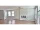Open living room with hardwood floors, fireplace, and natural light from the large windows at 1961 Ecoland Dr, Grayson, GA 30017