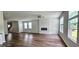 Spacious living room with hard wood flooring, modern fireplace, and multiple windows at 1961 Ecoland Dr, Grayson, GA 30017