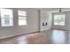 Open living room with hardwood floors, fireplace, and natural light from the large windows at 1961 Ecoland Dr, Grayson, GA 30017