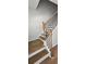 A set of wood-look stairs featuring a wooden banister with black metal spindles at 1961 Ecoland Dr, Grayson, GA 30017