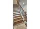 Stairs with wooden treads, white risers, black iron balusters, and a wooden handrail at 1961 Ecoland Dr, Grayson, GA 30017