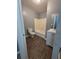 Bathroom with a white vanity, white tub, and wood-look vinyl flooring at 2802 3Rd Sw Ave, Atlanta, GA 30315