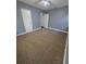 Spacious bedroom with neutral walls, plush carpet, ceiling fan, and closet for a comfortable space at 2802 3Rd Sw Ave, Atlanta, GA 30315