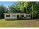 Charming single-story home with black shutters, surrounded by mature trees and a well-maintained lawn at 2802 3Rd Sw Ave, Atlanta, GA 30315