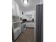 A galley kitchen features white cabinets and appliances, and a window over the sink at 2802 3Rd Sw Ave, Atlanta, GA 30315