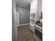 A galley kitchen features white cabinets, appliances, and light gray walls at 2802 3Rd Sw Ave, Atlanta, GA 30315