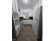 Galley kitchen with white cabinets and appliances, and a window over the sink at 2802 3Rd Sw Ave, Atlanta, GA 30315