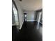 Open-concept living room featuring neutral walls, white trim and dark, hardwood floors at 2802 3Rd Sw Ave, Atlanta, GA 30315