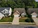 Overhead view of houses with well-kept lawns, driveways, and mature trees at 414 Norton Xing, Woodstock, GA 30188