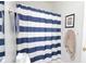 Cozy bathroom featuring a blue and white striped shower curtain at 414 Norton Xing, Woodstock, GA 30188