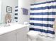 Bathroom featuring a gray vanity and blue striped shower curtain at 414 Norton Xing, Woodstock, GA 30188